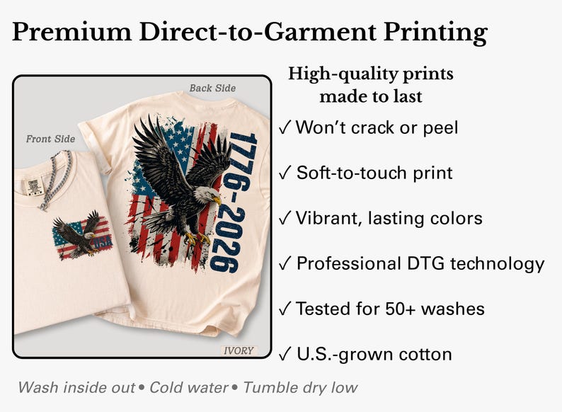 Pode incluir: Uma t-shirt cor de marfim com um gr&aacute;fico de uma &aacute;guia-de-cabe&ccedil;a-branca voando sobre uma bandeira americana desgastada e o texto 1776-2026. A imagem mostra as vistas frontal e traseira, destacando a impress&atilde;o direta, tinta suave ao toque, cores vibrantes e algod&atilde;o cultivado nos EUA.