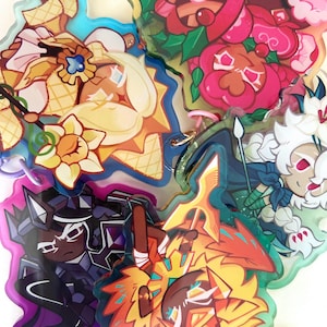 Könnte beinhalten: Eine Sammlung farbenfroher Acryl-Charms im Cartoon-Stil. Die Charms zeigen verschiedene Designs mit leuchtenden Farben, darunter Rot, Gelb, Blau und Schwarz. Jeder Charm hat ein einzigartiges Charakterdesign mit aufwendigen Details und einem glänzenden Finish.