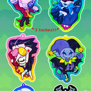 Könnte beinhalten: Acryl-Schlüsselanhänger mit Charakteren aus Deltarune Vol. 2. Die Schlüsselanhänger sind etwa 7,6 cm hoch und zeigen farbenfrohe Illustrationen verschiedener Charaktere. Die Schlüsselanhänger haben ein glänzendes Finish und sind im Cartoon-Stil gestaltet.
