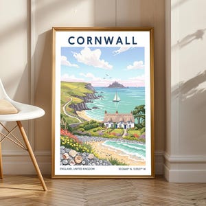 May include: A framed print featuring a coastal scene of Cornwall, England. The artwork depicts a white cottage with a thatched roof, a winding road, and a sailboat on the turquoise sea. The word "CORNWALL" is at the top.