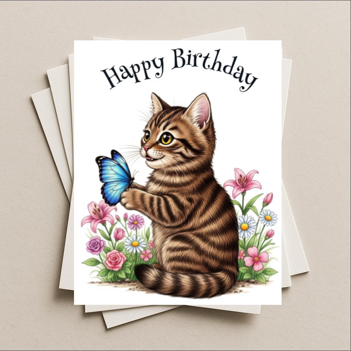 Birthday card butterfly brown tabby cat blank greeting card, note or gift card, kitten kitty, holding blue Morpho butterfly in a garden