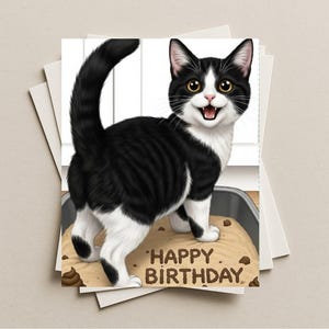 May include: A greeting card featuring a smiling black and white cat standing on a cake with the words "Happy Birthday" written in brown letters. The cat has yellow eyes and a fluffy tail. The card is on a stack of white cards.
