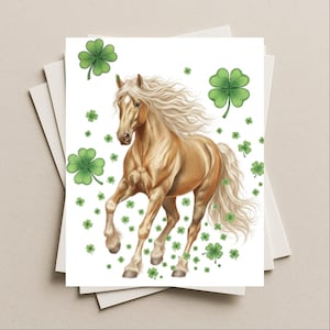 May include: A greeting card featuring a golden horse with a flowing mane and tail, surrounded by green shamrocks. The horse is depicted in a running pose against a white background, with various sizes of shamrocks scattered around.