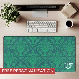 May include: A rectangular desk mat with a teal and green damask pattern. The mat features a repeating design of ornate vases and floral elements. The text "FREE PERSONALIZATION" is displayed in a red banner at the bottom. White initials "LCF" are in the lower right corner.