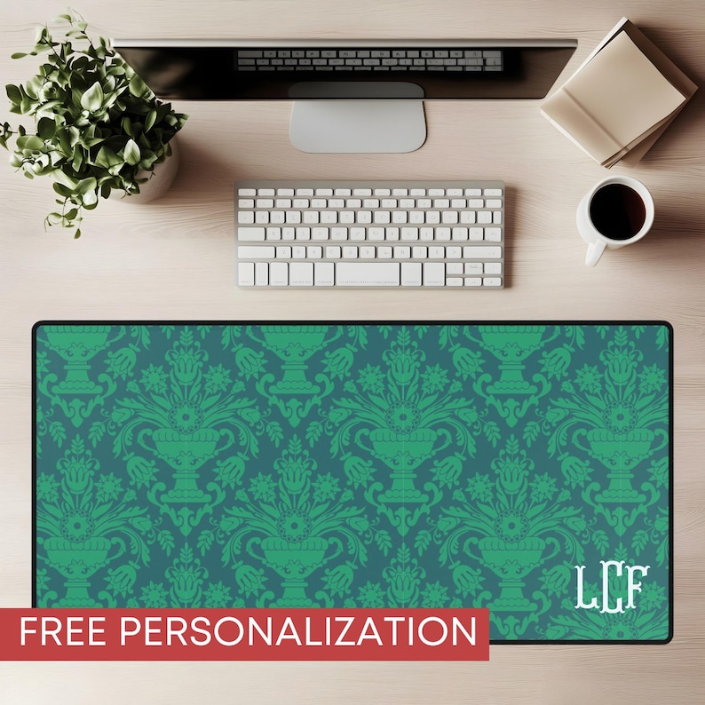 May include: A rectangular desk mat with a teal and green damask pattern. The mat features a repeating design of ornate vases and floral elements. The text "FREE PERSONALIZATION" is displayed in a red banner at the bottom. White initials "LCF" are in the lower right corner.