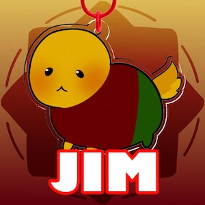 May include: A cartoon-style keychain featuring a yellow character with a red and green body. The keychain has a red loop at the top and the name "JIM" in white letters with a red outline at the bottom. The background is a gradient of brown and orange.
