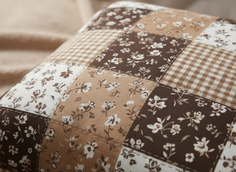 High-quality mocha patchwork pillow cover with floral prints and gingham detailing in rich brown, beige, and cream tones. Soft, cozy, and stylish neutral decor for living rooms, bedrooms, or dorm spaces. Aesthetic close-up highlighting stitching, texture, and warm tones. Perfect for hygge lovers, neutral decor, or anyone wanting a warm, inviting home look.