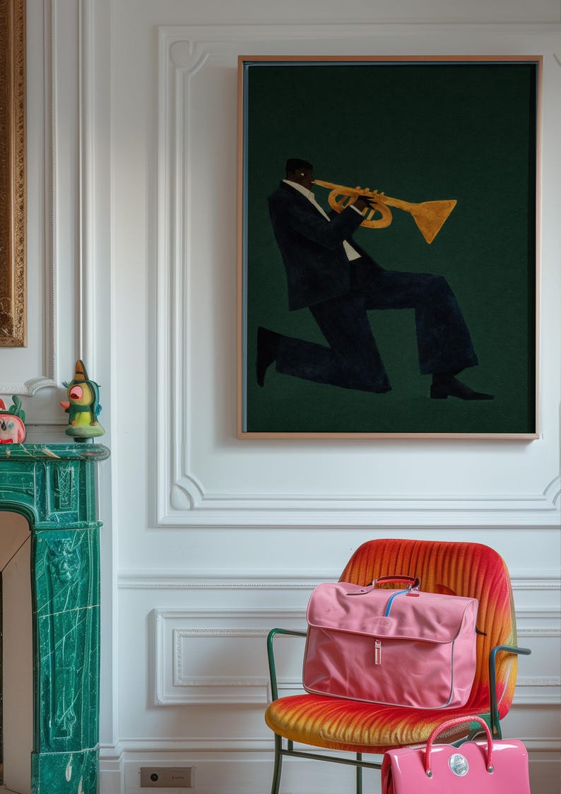 May include: An art print shows a musician playing a trumpet against a dark green backdrop. A pink satchel bag and a smaller pink handbag are on a colourful chair. The room has white walls and a green fireplace.