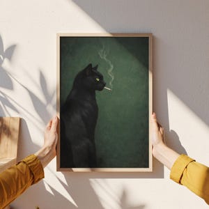 May include: A framed art print featuring a black cat with yellow eyes smoking a cigarette. The cat is set against a dark green background. The artwork is in a wooden frame.