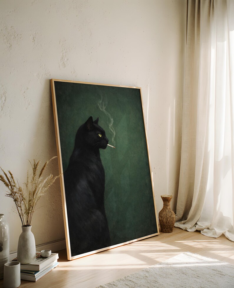 May include: A framed art print featuring a black cat with yellow eyes smoking a cigarette. The cat is set against a dark green background. The frame is a light wood color.