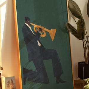 May include: A framed art print depicting a musician playing a gold trumpet. The figure is in a dark blue suit against a dark green backdrop. The frame is gold.