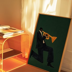 May include: A framed art print showing a musician playing a trumpet. The artwork features a figure in a dark suit against a deep green background. The trumpet is gold, and the frame is a light wood colour. The print is suitable for home decor.