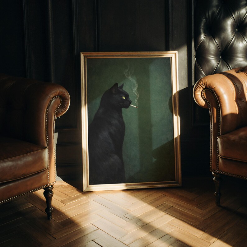 May include: A framed art print featuring a black cat with yellow eyes smoking a cigarette. The cat is set against a dark green background. The frame is gold-colored, and the artwork is displayed in a room with leather armchairs.