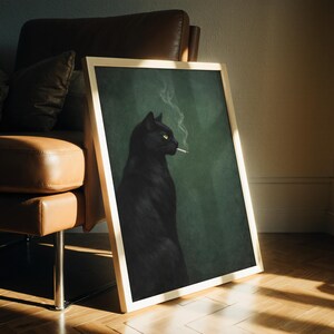 May include: A framed art print featuring a black cat with yellow eyes smoking a cigarette. The cat is set against a dark green background. The frame is a light wood color.