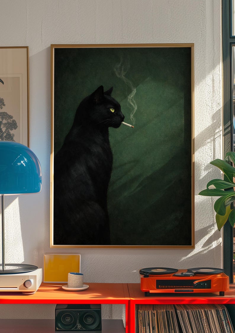 May include: A framed art print featuring a black cat with yellow eyes smoking a cigarette. The cat is set against a dark green background. The artwork is displayed in a room with a record player and other decor.