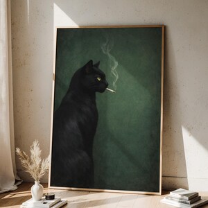 May include: A framed art print featuring a black cat with yellow eyes smoking a cigarette. The cat is set against a dark green background. The artwork is displayed in a room with a wooden floor and a vase of dried flowers.