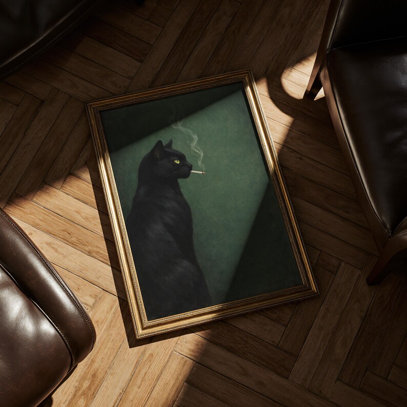 May include: A framed art print featuring a black cat with yellow eyes smoking a cigarette. The cat is set against a dark green background, framed in gold, and resting on a wooden floor.
