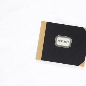 May include: A black notebook with a brown spine and a label that reads "Privatbereich".