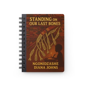 May include: A spiral-bound notebook with a cover design. The cover features the title "STANDING ON OUR LAST BONES" and the author's name. The design includes stylized bones with words like "Love," "Grief," and "Hope." A silhouette of a person writing is also visible.