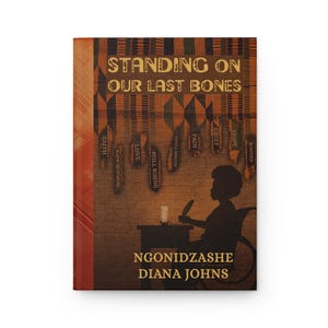 May include: A book cover with the title "STANDING ON OUR LAST BONES". The design includes a silhouette of a person in a wheelchair, a table, and decorative elements in brown, orange, and black.
