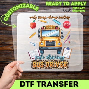 May include: A DTF transfer featuring a yellow school bus with the text "SCHOOL BUS". The design includes an apple, pencils, rulers, and the words "early rising, always smiling" and "safe driving BUS DRIVER".