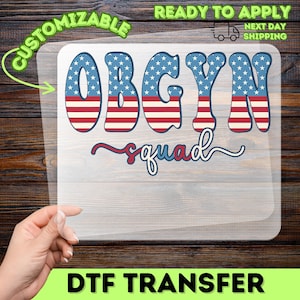 May include: A DTF transfer featuring the text "OBGYN squad" in a patriotic design with red, white, and blue colors. The letters are filled with a star-spangled pattern and red and white stripes. The transfer is ready to apply.