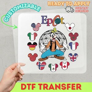 May include: A DTF transfer featuring Goofy in front of a geometric sphere, surrounded by Mickey Mouse heads with flags. The flags include the USA, Italy, Germany, China, Japan, Morocco, France, and the UK. The word "Epcot" is at the top.