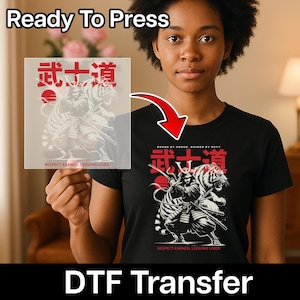May include: Black t-shirt with a graphic of a samurai and tiger, with Japanese text and the words "Respect Earned, Lessons Lived." The image also shows a DTF transfer with the same design, and the words "Ready To Press."