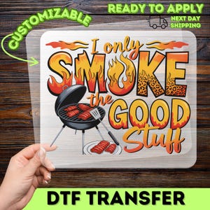 May include: DTF transfer with the text "I only smoke the good stuff" in orange and yellow, with a leopard print pattern. The design includes a black grill with red meat and the words "Customizable" and "Ready to Apply".