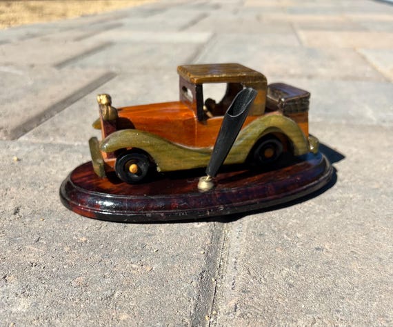 A hand-carved Model T Ford that moonlights as a pen holder — sculptural, nostalgic, and the kind of thing that stops visitors in their tracks.