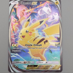 May include: A Pikachu EX Pokémon trading card. The card features a yellow Pikachu with a lightning bolt tail, surrounded by a colorful background with other Pokémon. The card has text that reads "Circle Circuit" and "HP 120".