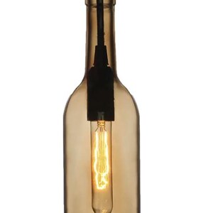 May include: A pendant light made from a recycled amber wine bottle. It features a long, Edison-style bulb. A black cord suspends the light, offering a unique, rustic lighting solution. The bottle is approximately 25 cm in height.
