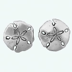 May include: A pair of silver sand dollar earrings. Each earring features a detailed sand dollar design with a five-pointed star in the center.