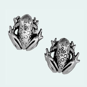 May include: A pair of silver frog stud earrings. The frogs are detailed with raised spots and have a realistic appearance.