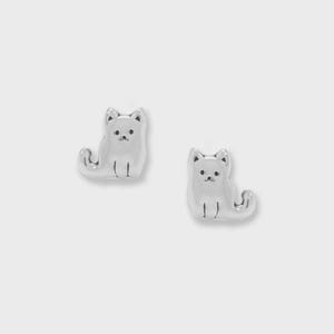 May include: A pair of silver-colored cat-shaped stud earrings. Each earring features a sitting cat with a rounded body, small ears, and a detailed face. The earrings are set against a plain white background.