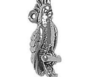 May include: A silver charm of a parrot perched on a branch. The parrot has a detailed design with feathers and a crest. The charm has a loop for attaching to a bracelet or necklace.