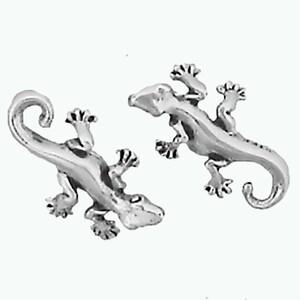 May include: A pair of silver-toned gecko earrings. Each earring features a detailed gecko design with a curled tail.