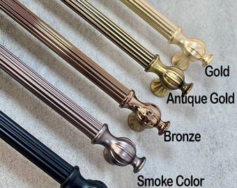 May include: A selection of decorative curtain rods in gold, antique gold, bronze, smoke colour, and black finishes. Each rod has a ribbed design and decorative finials. The colour names are labelled on the image.