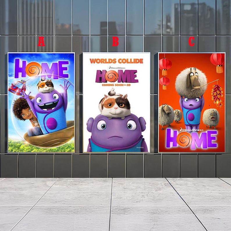 May include: Three movie posters for the animated film "Home" are displayed. Each poster features the film's title and characters, including a purple alien and a cat-like creature. The posters are set against a modern building backdrop.