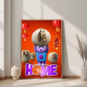 May include: A framed movie poster for the animated film "Home" featuring characters in a vibrant orange setting. The poster includes the DreamWorks logo and the title "HOME" in large, colorful letters. Decorative red lanterns and cartoon sheep are also visible.