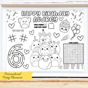 May include: A black and white personalized party placemat with the text "Happy Birthday Audrey". The placemat includes a maze, tic-tac-toe, word search, and various cartoon animal illustrations. The bottom banner reads "Personalized Party Placemat".
