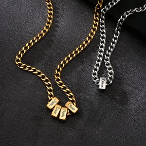 May include: Gold and silver chain necklaces with personalized name pendants. The gold chain has four rectangular pendants with the names "Jason", "Susan", "Betty", and "Oliver". The silver chain has one pendant with the name "Lucas".