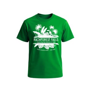 May include: A green t-shirt with a white graphic design featuring the text "Rainforest Falls" and "Exploring the Nature of God." The design includes palm trees and other tropical elements. The text "Your Church Here - VBS 2026" is also included.