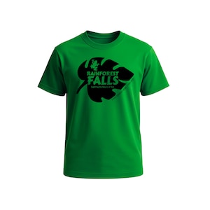 May include: A bright green t-shirt featuring a black graphic of a leaf with a frog and the words "Rainforest Falls" and "Exploring the Future of God". The text "YOUR CHURCH HERE - VBS 2024" is also included.
