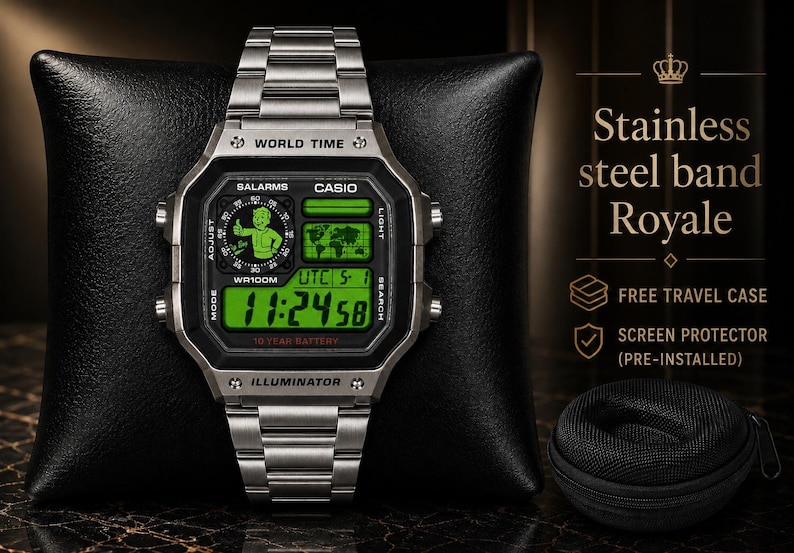 May include: A silver-tone stainless steel digital watch with a green backlit display featuring a Fallout Vault Boy graphic, world time, and 10-year battery text. The watch includes a metal link band and is displayed with a small black travel case.