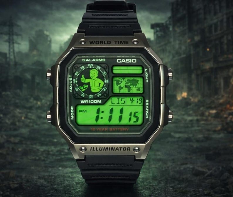 May include: A black digital wristwatch with a metallic bezel and a bright green display. The screen features a world map, a digital time readout, and a circular graphic of a cartoon character giving a thumbs up. Text includes CASIO, WORLD TIME, 5 ALARMS, WR100M, 10 YEAR BATTERY, and ILLUMINATOR.