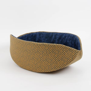 Our innovative Cat Canoe modern cat bed in a contrasting yellow and blue grid print with an unusual textured look. Our flexible beds are made with inner foam panels, are washable, and ready to ship. Fits cats to about 18 pounds, made in the USA.