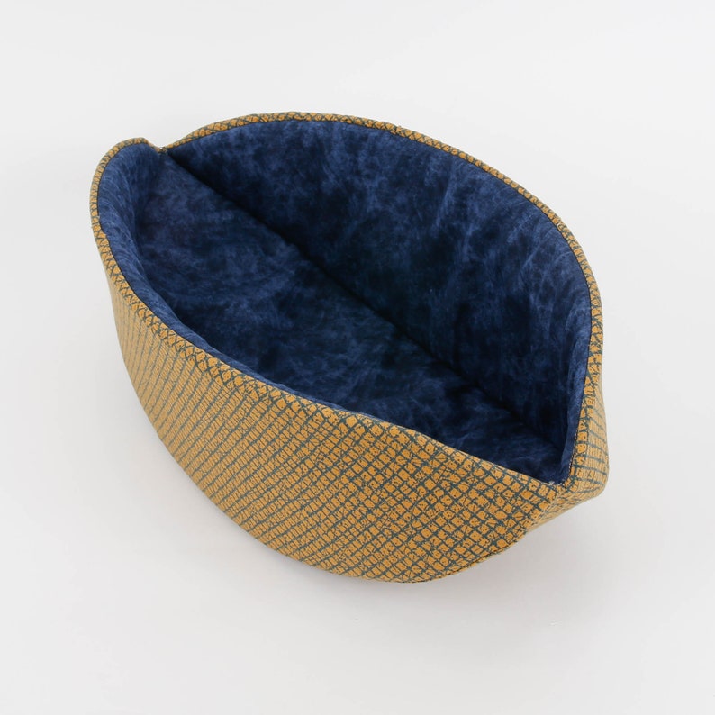 Our innovative Cat Canoe modern cat bed in a contrasting yellow and blue grid print with an unusual textured look. Our flexible beds are made with inner foam panels, are washable, and ready to ship. Fits cats to about 18 pounds, made in the USA.