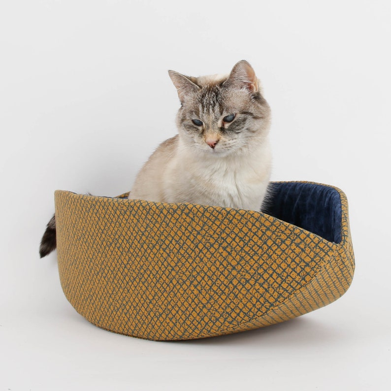 Our innovative Cat Canoe modern cat bed in a contrasting yellow and blue grid print with an unusual textured look. Our flexible beds are made with inner foam panels, are washable, and ready to ship. Fits cats to about 18 pounds, made in the USA.