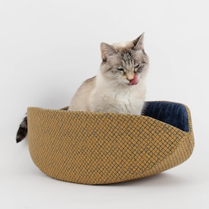 Our innovative Cat Canoe modern cat bed in a contrasting yellow and blue grid print with an unusual textured look. Our flexible beds are made with inner foam panels, are washable, and ready to ship. Fits cats to about 18 pounds, made in the USA.